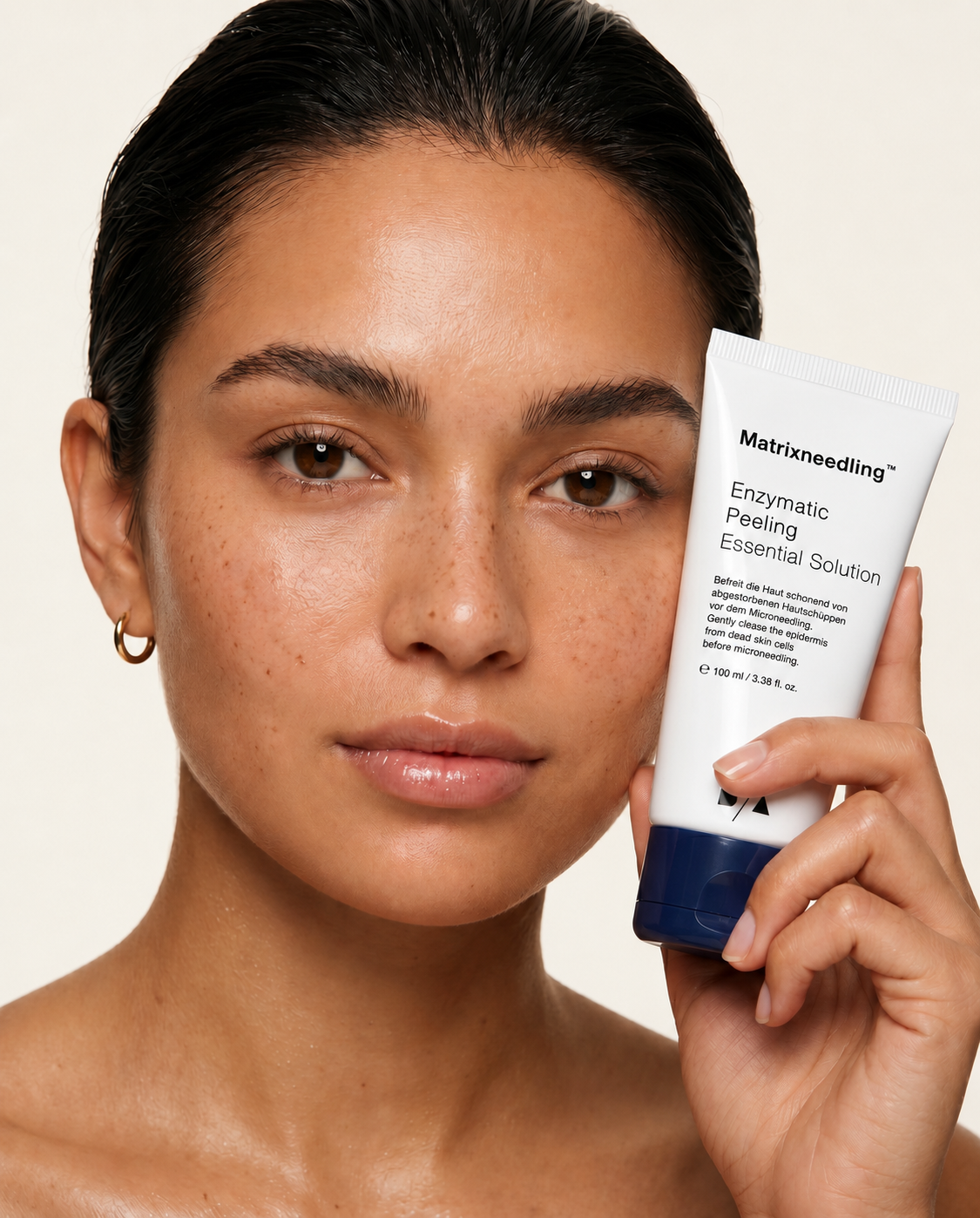 Vrouw met egale, stralende huid houdt Matrixneedling Enzymatic Peeling Essential Solution vast